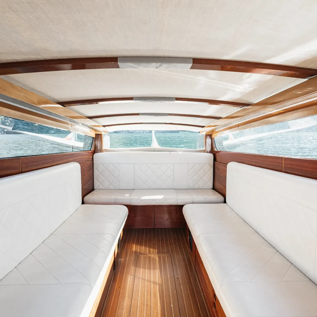 Interior view of Il Medeghino water taxi with rain cover on Lake Como