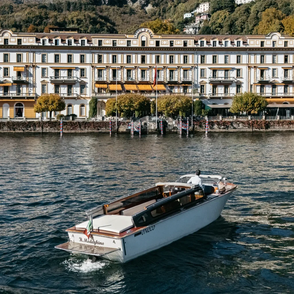 Water taxi passing in front of Villa d&rsquo;Este on Lake Como