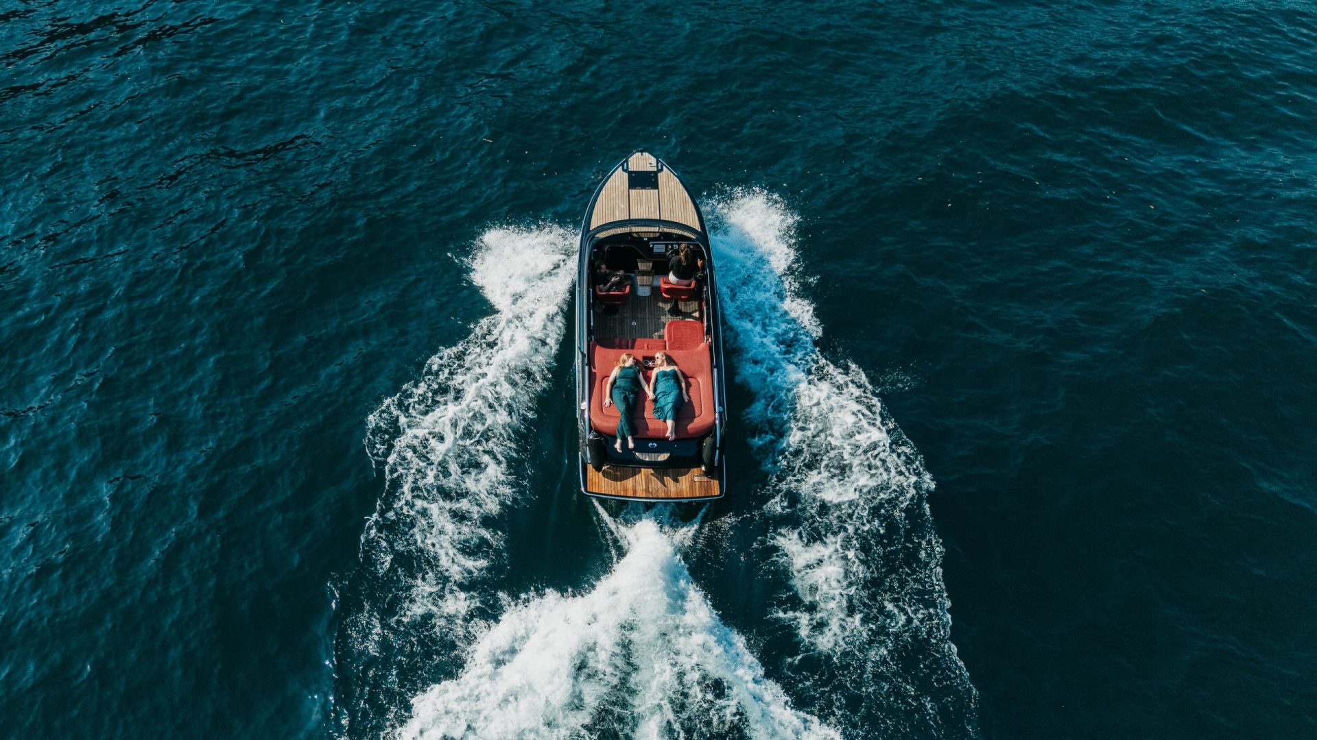 Aerial drone view of a couple during a photoshoot on a Cranchi E26 on Lake Como
